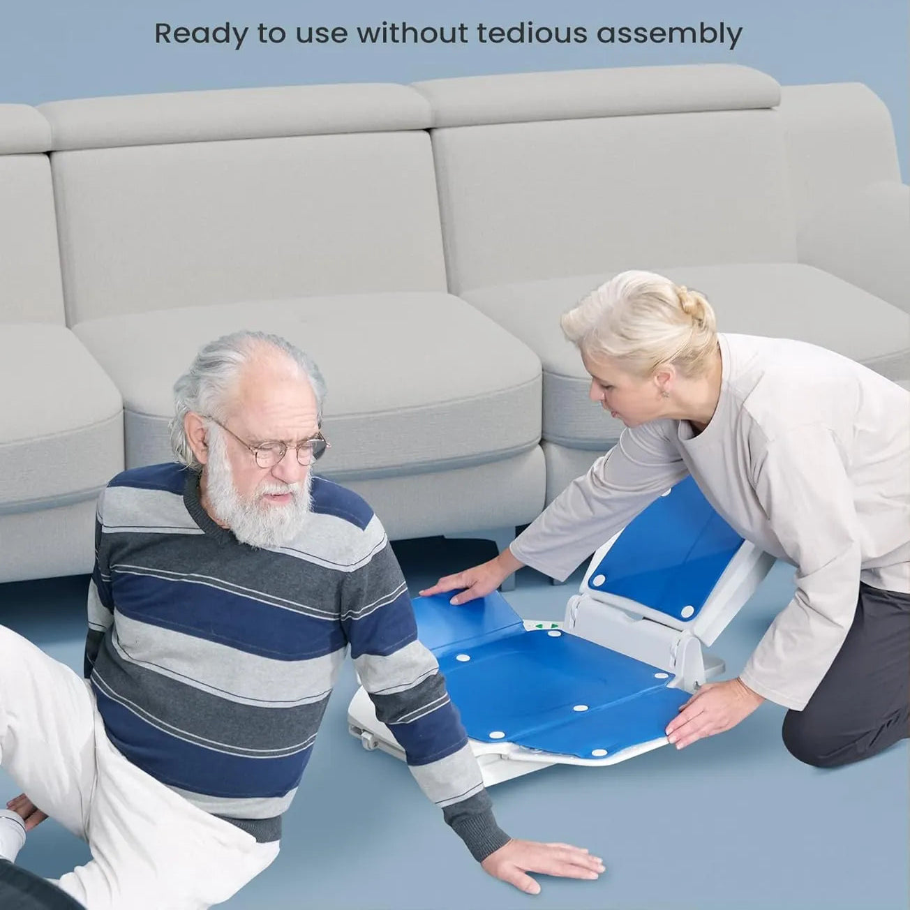 Senior couple using a blue mobility device in a living room.
