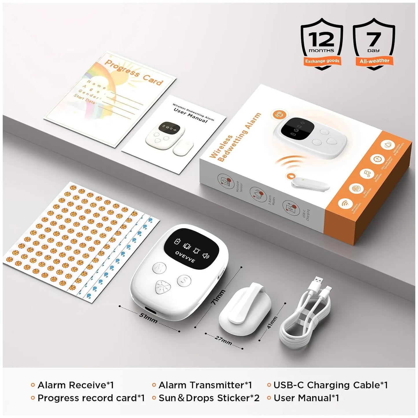 White wireless bedwetting alarm kit with a small alarm unit, matching receiver, USB-C charging cable, progress card, user manual, and sticker sheet, arranged on a light gray surface with the product box. Black badge graphics show 12 months warranty.